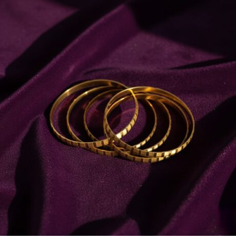 Set of Four Gold Tone Stackable Patterned Bangles